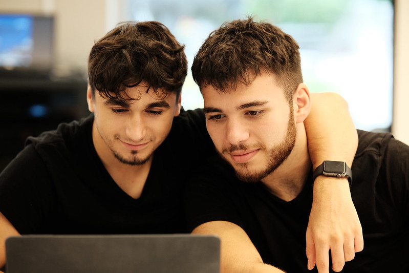 Two students looking at a laptop together